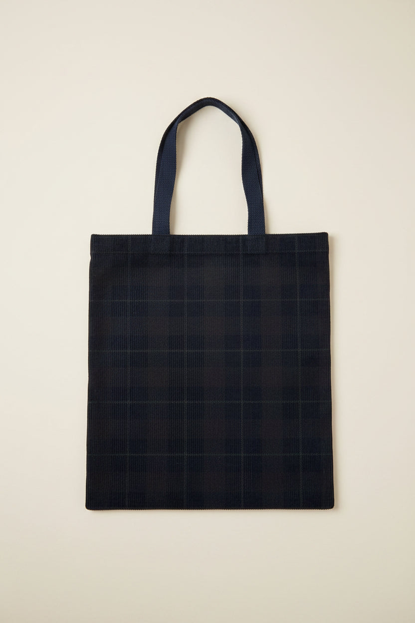 

Navy Blue Corduroy tote bag with grid pattern on a beige surface.